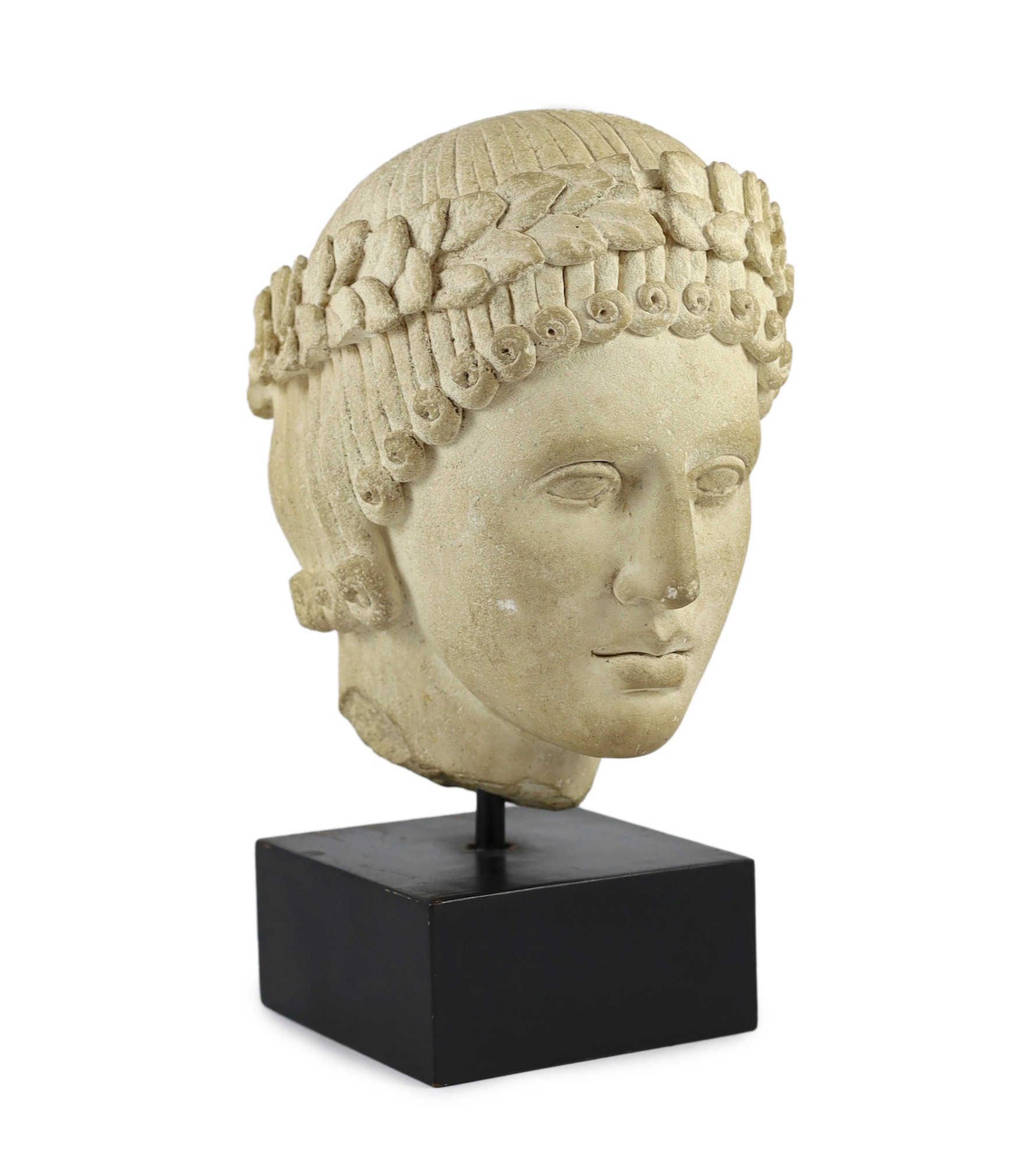 An antique limestone head wearing a laurel wreath diadem, possibly 18th/19th century, 29cm high overall 39cm